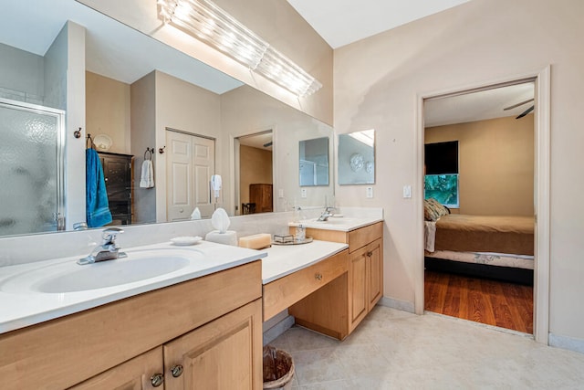 bathroom with a shower with door, vanity, and wood-type flooring