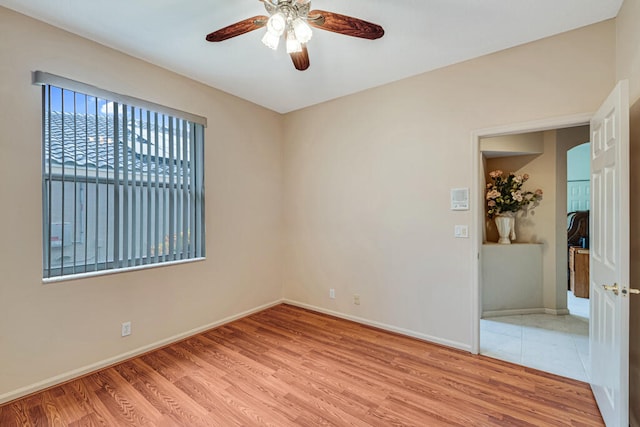 spare room featuring light hardwood / wood-style flooring and ceiling fan