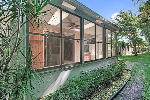 view of side of home with a lawn and a sunroom