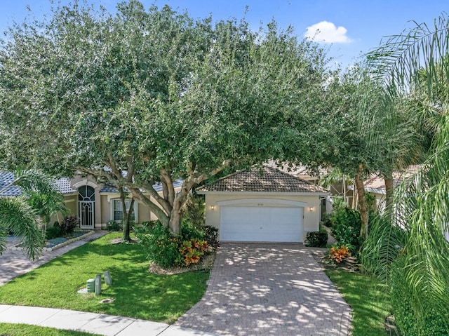 view of front of property with a front lawn and a garage