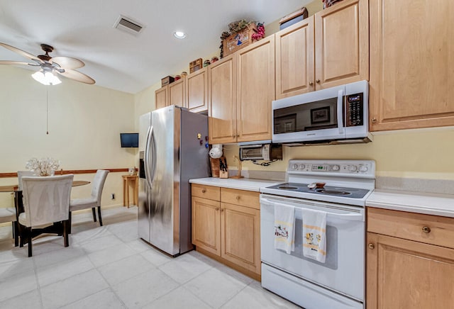 kitchen featuring white appliances, ceiling fan, and light brown cabinetry