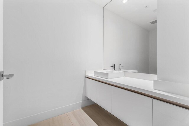 bathroom with vanity and wood-type flooring