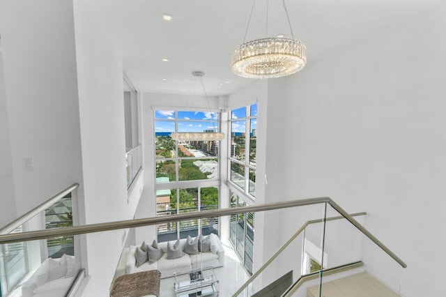 stairs featuring a chandelier