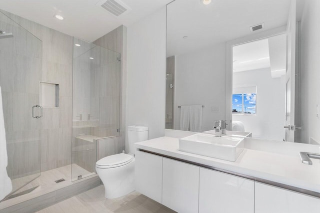 ensuite bathroom featuring toilet, a shower stall, visible vents, and connected bathroom