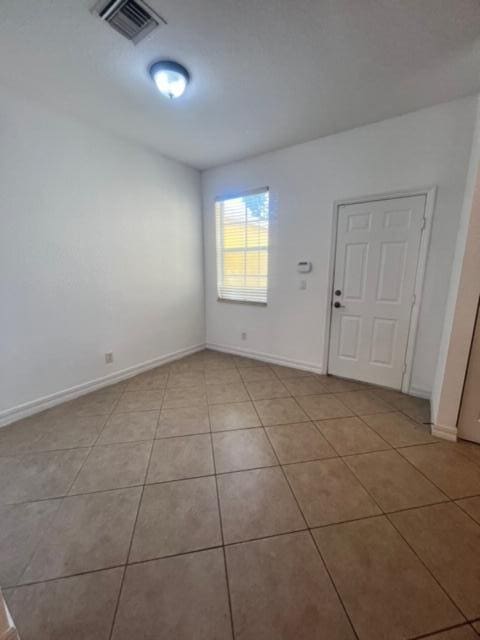 empty room with light tile patterned floors