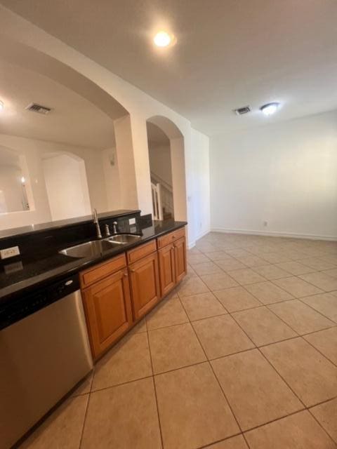 kitchen featuring dishwasher, light tile patterned floors, and sink