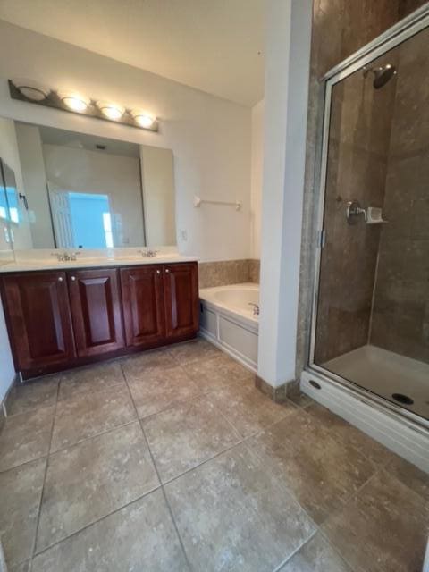 bathroom with vanity, plus walk in shower, and tile patterned flooring