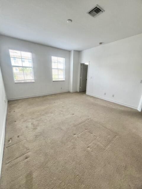 spare room with light carpet