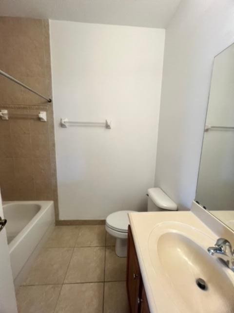 full bathroom with tile patterned flooring, vanity, toilet, and tiled shower / bath combo