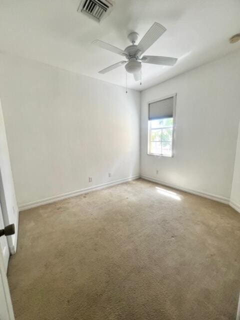 unfurnished room with ceiling fan and light colored carpet