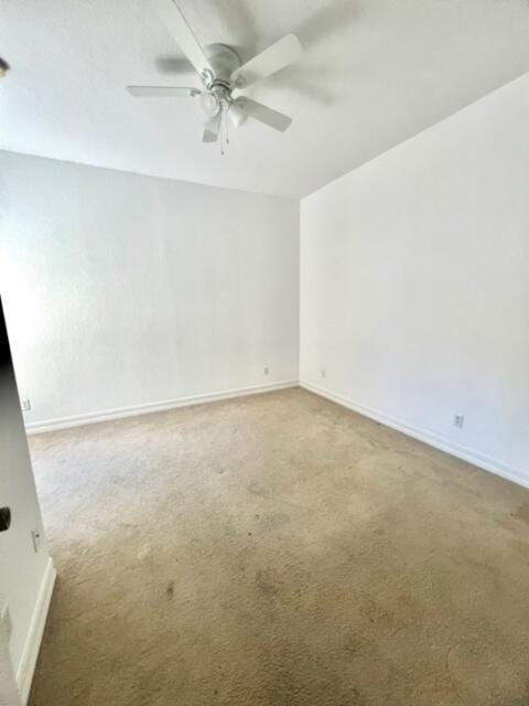 spare room with ceiling fan and carpet floors