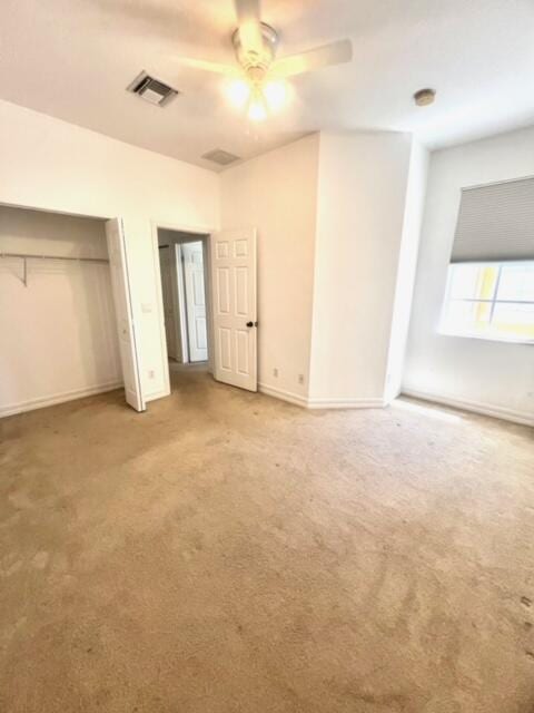 unfurnished bedroom featuring ceiling fan and light carpet