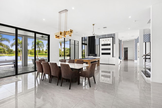 dining area with a wall of windows, ceiling fan, and billiards