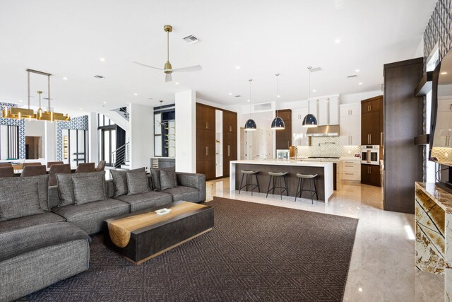 bedroom featuring dark hardwood / wood-style flooring, access to outside, ceiling fan, and a tray ceiling