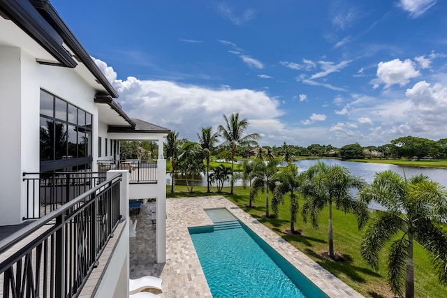 view of swimming pool with a water view and a patio area