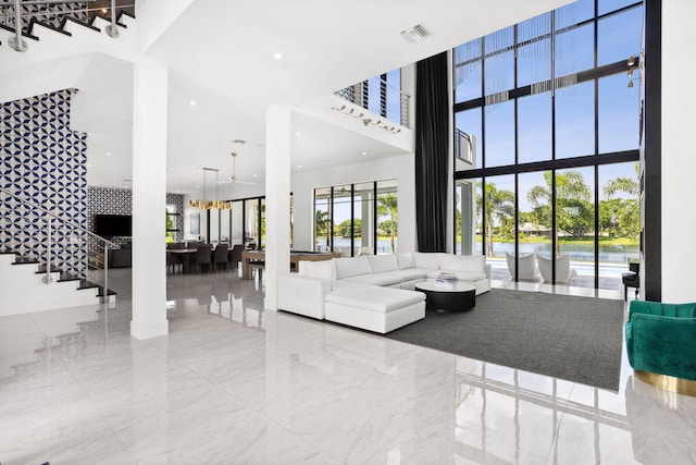 living room featuring expansive windows and a towering ceiling