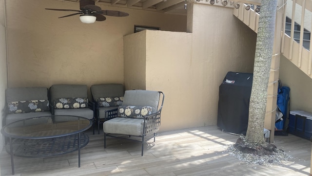 view of patio / terrace with ceiling fan and an outdoor living space