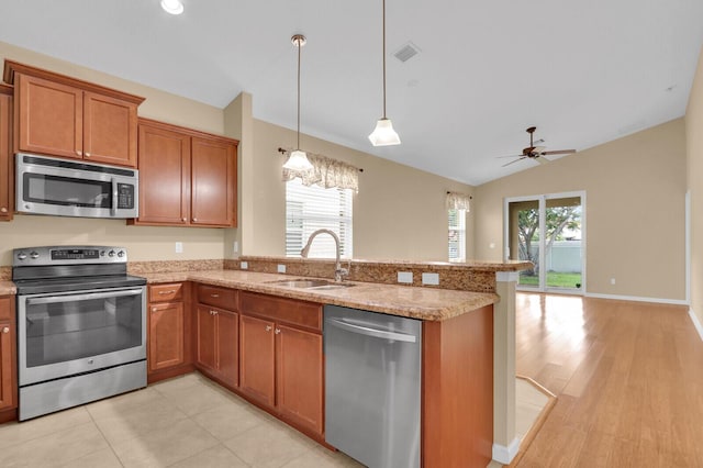 2609 SW Gallery Cir, Palm City, FL 34990 - kitchen featuring stainless steel appliances, a sink, a peninsula, brown cabinetry, and ceiling fan