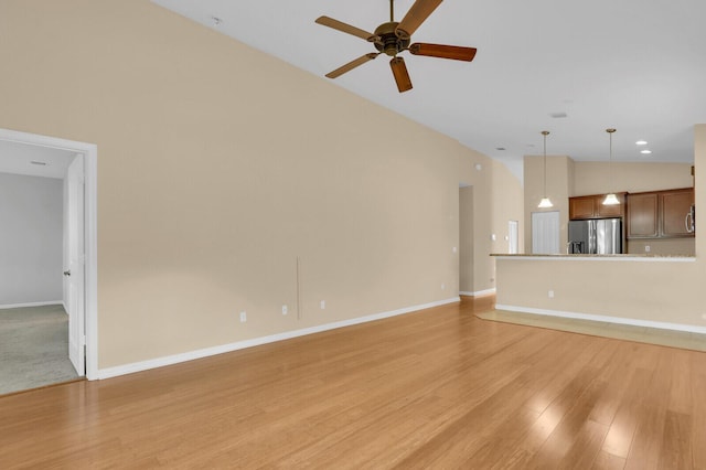 2609 SW Gallery Cir, Palm City, FL 34990 - unfurnished living room with ceiling fan, light wood-style floors, baseboards, and high vaulted ceiling