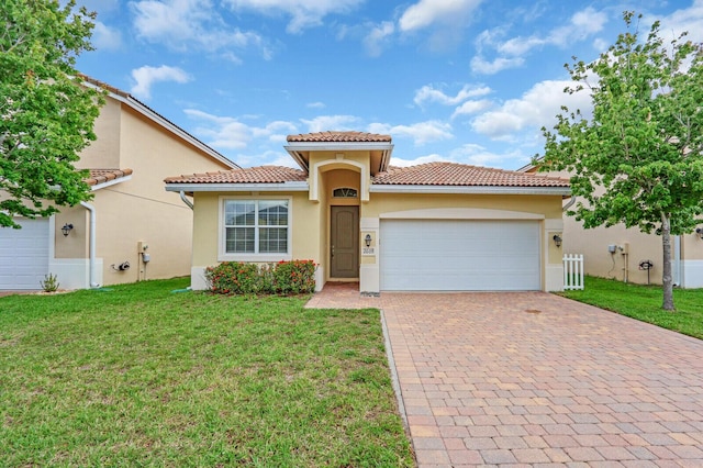 2609 SW Gallery Cir, Palm City, FL 34990 - mediterranean / spanish house with a tile roof, decorative driveway, stucco siding, a garage, and a front yard