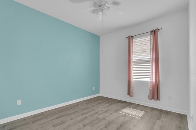 2609 SW Gallery Cir, Palm City, FL 34990 - spare room with wood finished floors, ceiling fan, and baseboards