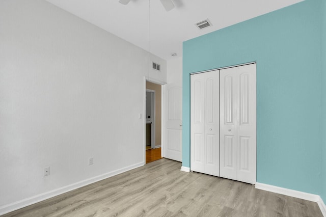 2609 SW Gallery Cir, Palm City, FL 34990 - unfurnished bedroom featuring wood finished floors, a closet, baseboards, and a ceiling fan