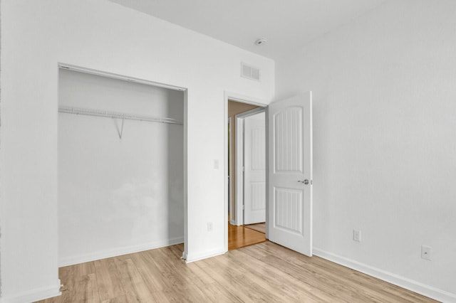 2609 SW Gallery Cir, Palm City, FL 34990 - unfurnished bedroom featuring wood finished floors, a closet, and baseboards