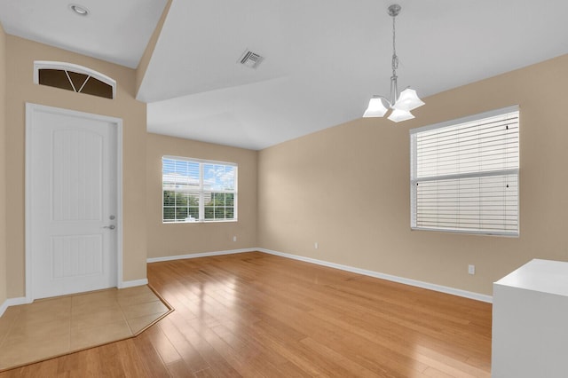 2609 SW Gallery Cir, Palm City, FL 34990 - unfurnished room featuring a chandelier, light wood-style flooring, baseboards, and lofted ceiling