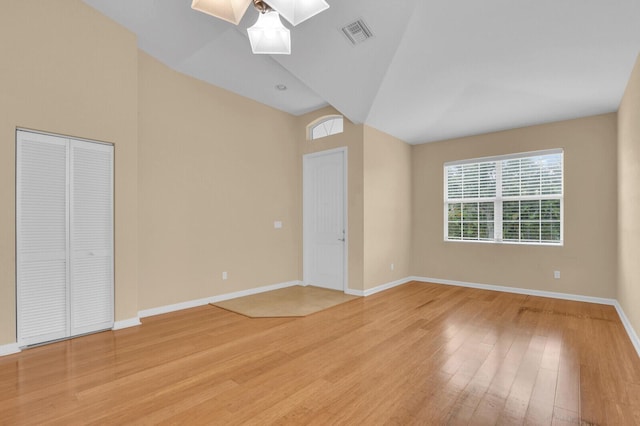 2609 SW Gallery Cir, Palm City, FL 34990 - unfurnished bedroom with a skylight, light wood-style floors, multiple windows, baseboards, and high vaulted ceiling