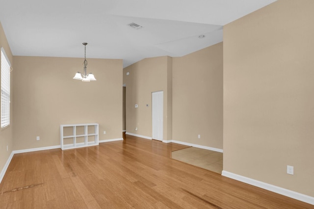 2609 SW Gallery Cir, Palm City, FL 34990 - empty room featuring wood finished floors, a chandelier, and baseboards