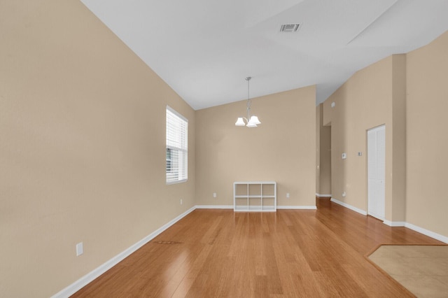 2609 SW Gallery Cir, Palm City, FL 34990 - unfurnished room with light wood-style floors, a chandelier, lofted ceiling, and baseboards