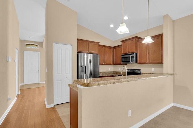 2609 SW Gallery Cir, Palm City, FL 34990 - kitchen featuring stainless steel appliances, brown cabinets, a peninsula, hanging light fixtures, and baseboards