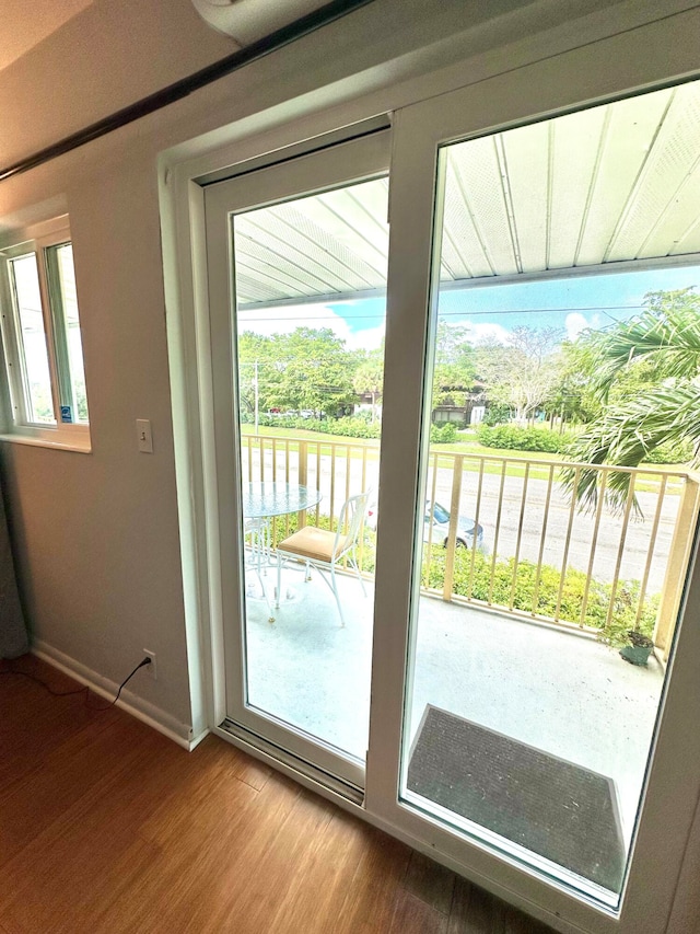 entryway with a healthy amount of sunlight, hardwood / wood-style floors, and a water view