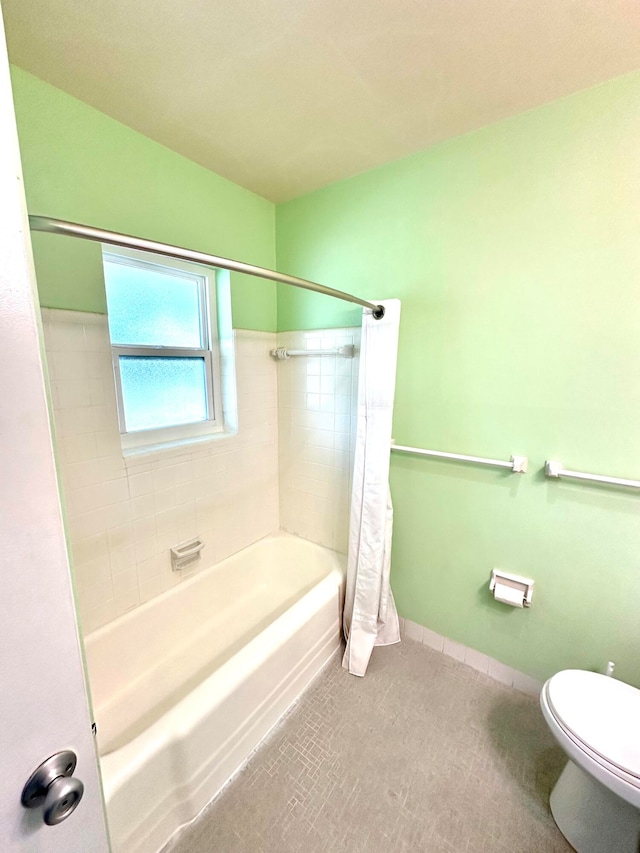 bathroom with shower / bath combination with curtain and toilet