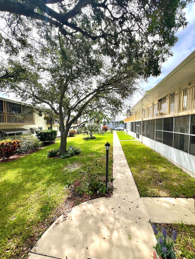 view of property's community with a lawn