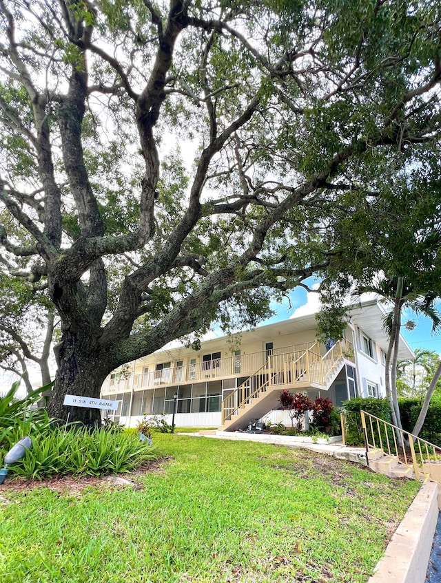 back of house with a lawn