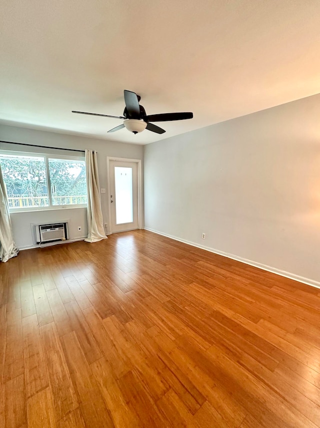 unfurnished living room featuring a wall mounted AC, ceiling fan, and light hardwood / wood-style floors