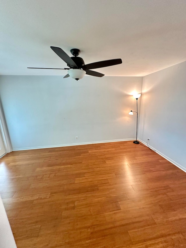 empty room with light wood-type flooring and ceiling fan