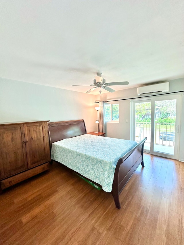 bedroom featuring access to exterior, ceiling fan, a wall unit AC, and wood-type flooring