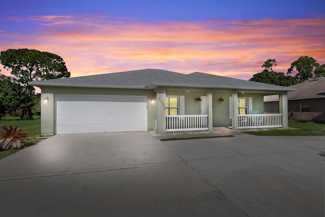 view of front of home with covered porch and a garage