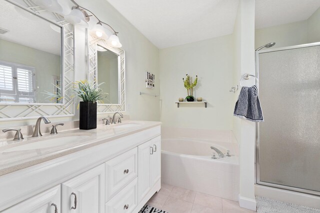 bathroom featuring plus walk in shower, vanity, and tile patterned floors