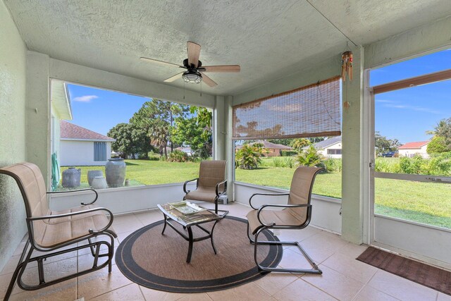 sunroom / solarium featuring ceiling fan and plenty of natural light