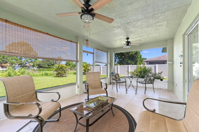 sunroom featuring a wealth of natural light and ceiling fan