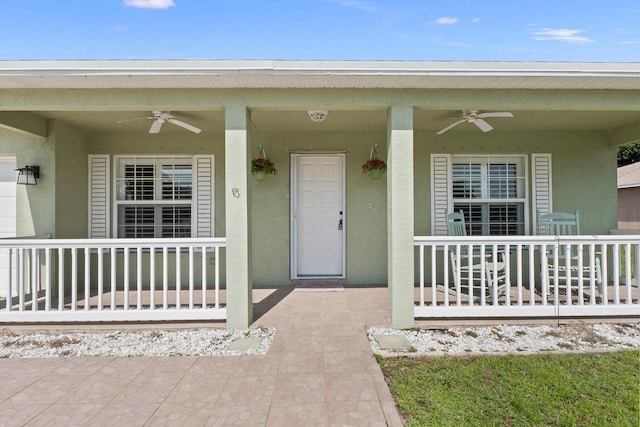 entrance to property featuring covered porch and ceiling fan