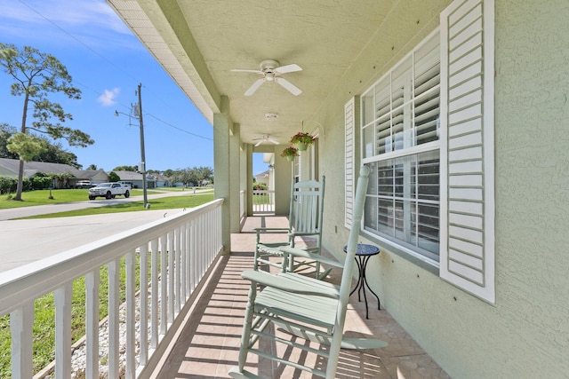 balcony with covered porch and ceiling fan