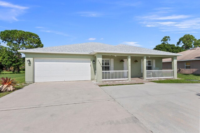 ranch-style home with a garage and covered porch