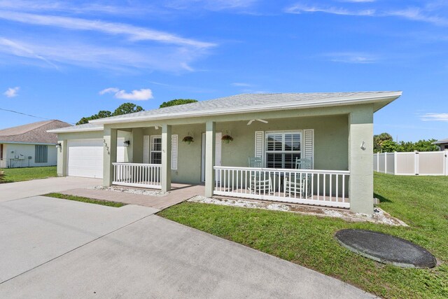 ranch-style home with a front yard, a porch, and a garage