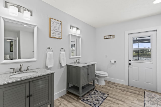 bathroom featuring hardwood / wood-style floors, toilet, and vanity