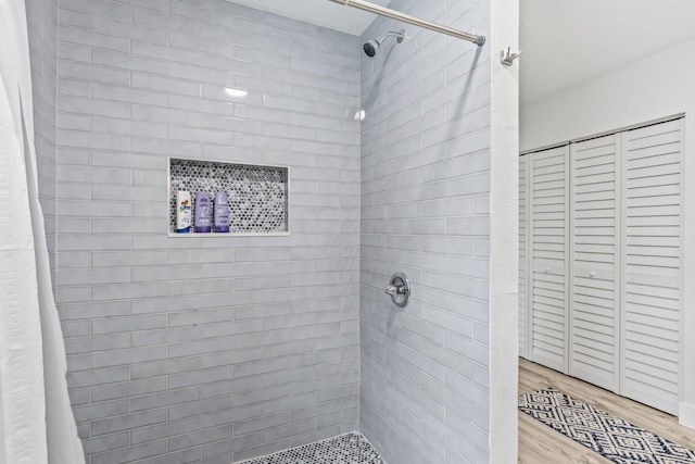 bathroom featuring hardwood / wood-style flooring and curtained shower