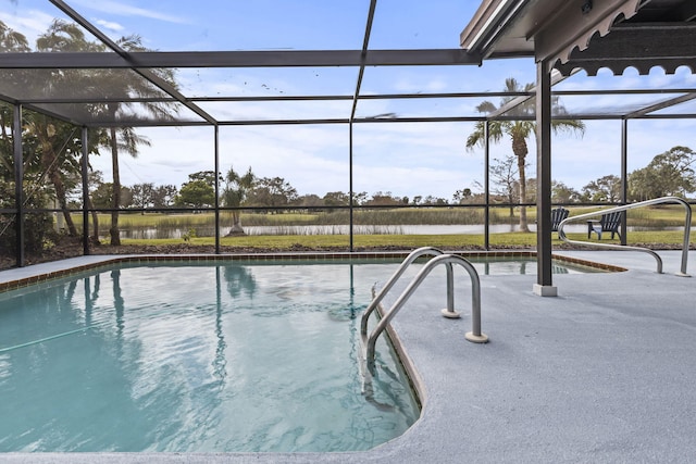 view of pool with a water view and a lanai